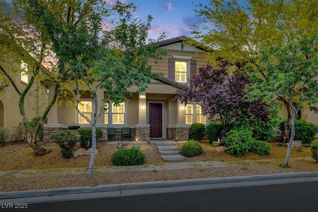 3141 Monet Sunrise Ave, Henderson, NV 89044 - view of front of home with stone siding, stucco siding, and a porch
