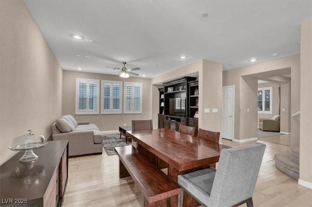dining room with a ceiling fan, light wood finished floors, plenty of natural light, baseboards, and recessed lighting