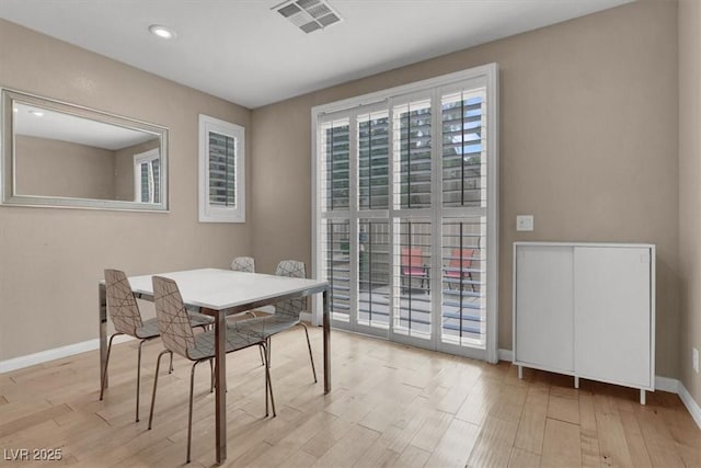 dining area with wood finished floors, baseboards, and recessed lighting