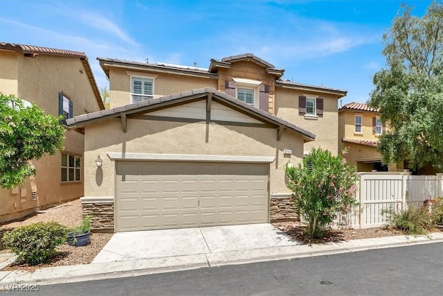 3141 Monet Sunrise Ave, Henderson, NV 89044 - view of front of home with stone siding, stucco siding, driveway, and an attached garage