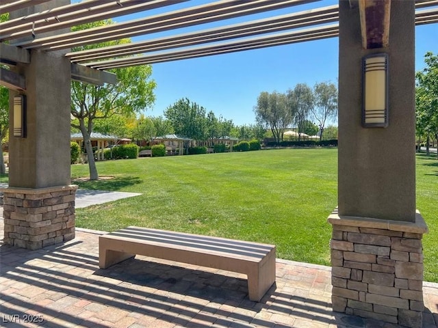 view of community featuring a pergola and a lawn