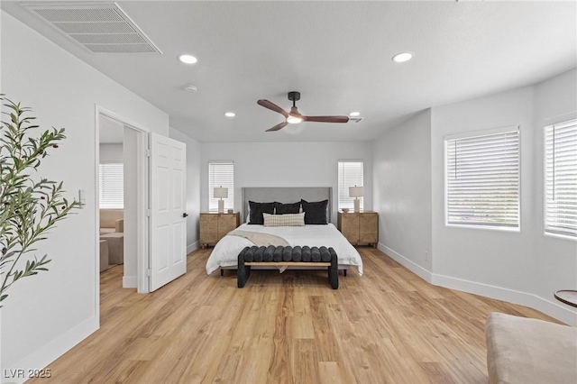 bedroom featuring multiple windows, baseboards, light wood-style floors, and recessed lighting