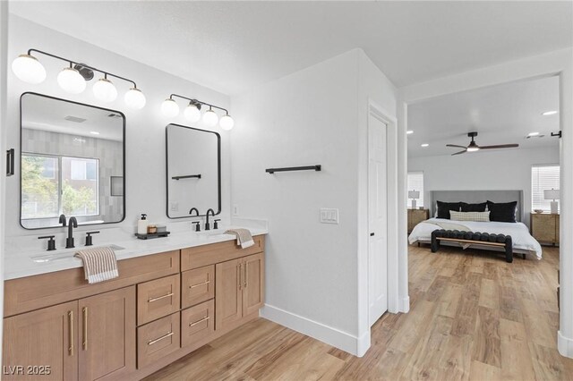 full bathroom featuring wood finished floors, ensuite bath, ceiling fan, and healthy amount of natural light