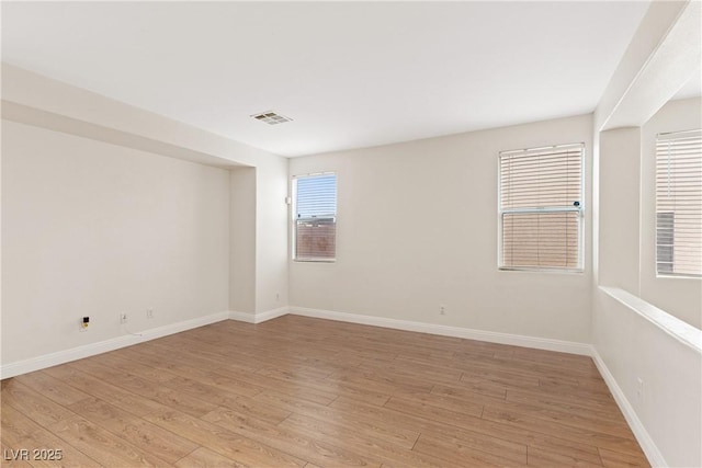 unfurnished room featuring light wood-style floors and baseboards