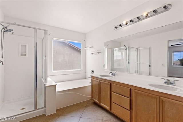 full bath featuring a shower stall, healthy amount of natural light, tile patterned flooring, and double vanity