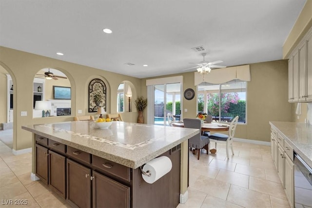 8608 Willow Cabin St, Las Vegas, NV 89131 - kitchen featuring ceiling fan, baseboards, stainless steel dishwasher, light stone counters, and recessed lighting
