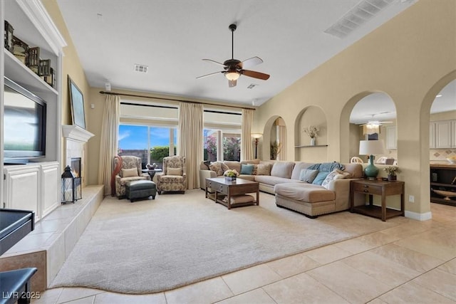8608 Willow Cabin St, Las Vegas, NV 89131 - living area featuring ceiling fan, light tile patterned floors, arched walkways, and a high ceiling