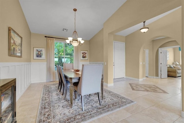 8608 Willow Cabin St, Las Vegas, NV 89131 - dining area with vaulted ceiling, a chandelier, light tile patterned floors, and arched walkways