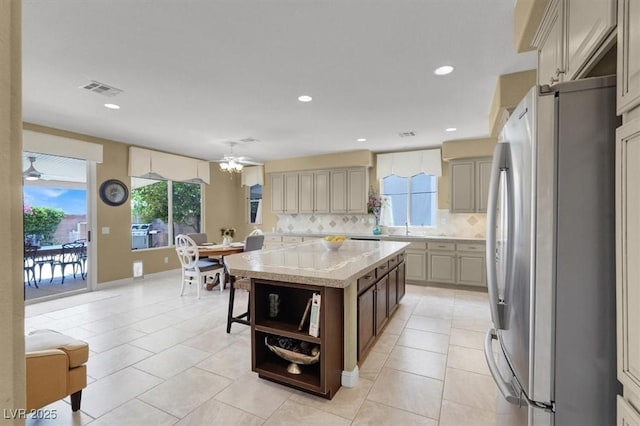8608 Willow Cabin St, Las Vegas, NV 89131 - kitchen with freestanding refrigerator, decorative backsplash, plenty of natural light, a center island, and recessed lighting