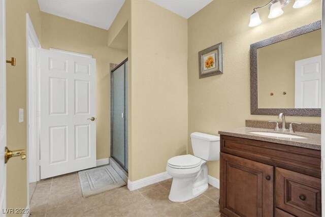 8608 Willow Cabin St, Las Vegas, NV 89131 - bathroom with a stall shower, toilet, vanity, tile patterned floors, and baseboards