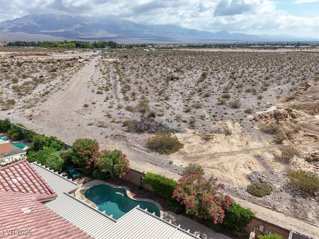 8608 Willow Cabin St, Las Vegas, NV 89131 - aerial view of sparsely populated area featuring a desert landscape, a mountain backdrop, and a pool