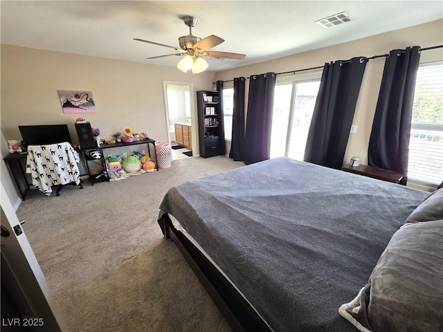 bedroom featuring carpet, ceiling fan, and ensuite bathroom