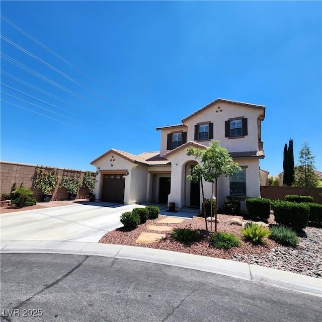 mediterranean / spanish home featuring stucco siding, concrete driveway, a garage, and a tile roof