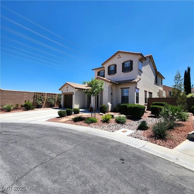 mediterranean / spanish-style home featuring stucco siding, driveway, and an attached garage