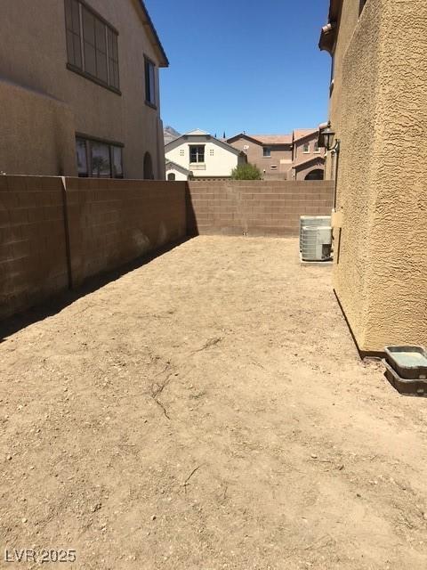 fenced backyard featuring cooling unit