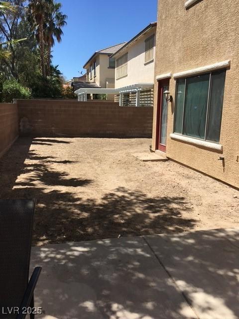 fenced backyard with a patio area