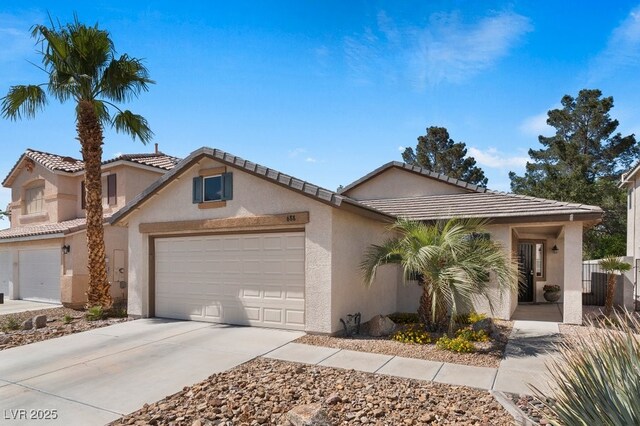 688 Castlebridge Ave, Las Vegas, NV 89123 - view of front of home featuring stucco siding, a garage, concrete driveway, and a tile roof