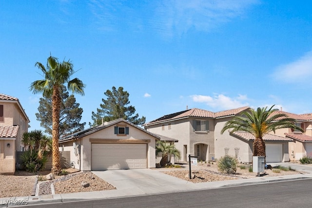 688 Castlebridge Ave, Las Vegas, NV 89123 - mediterranean / spanish home with an attached garage, driveway, stucco siding, and a tile roof