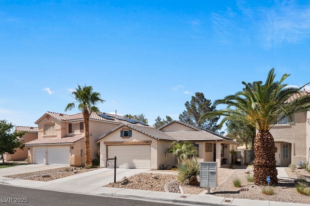 688 Castlebridge Ave, Las Vegas, NV 89123 - view of front of house featuring concrete driveway, stucco siding, roof mounted solar panels, a tiled roof, and an attached garage