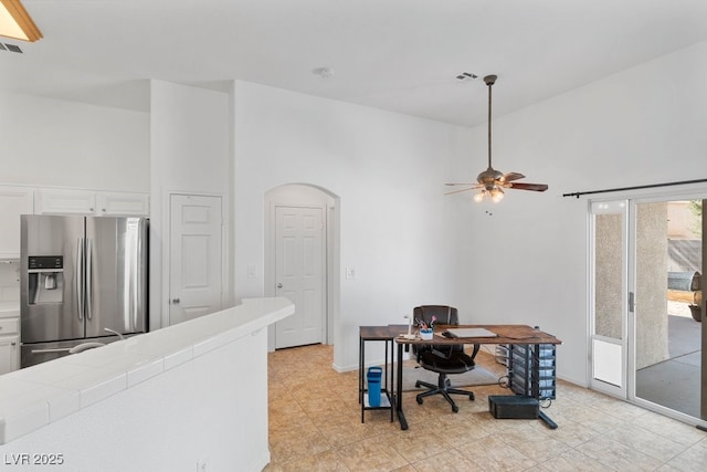 688 Castlebridge Ave, Las Vegas, NV 89123 - home office featuring a towering ceiling, ceiling fan, arched walkways, and light tile patterned floors