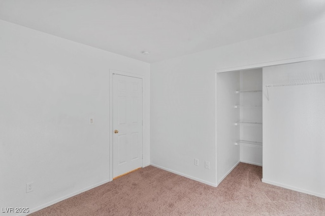688 Castlebridge Ave, Las Vegas, NV 89123 - unfurnished bedroom featuring a closet, light colored carpet, and baseboards