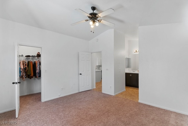 688 Castlebridge Ave, Las Vegas, NV 89123 - unfurnished bedroom featuring light colored carpet, a walk in closet, vaulted ceiling, a closet, and baseboards