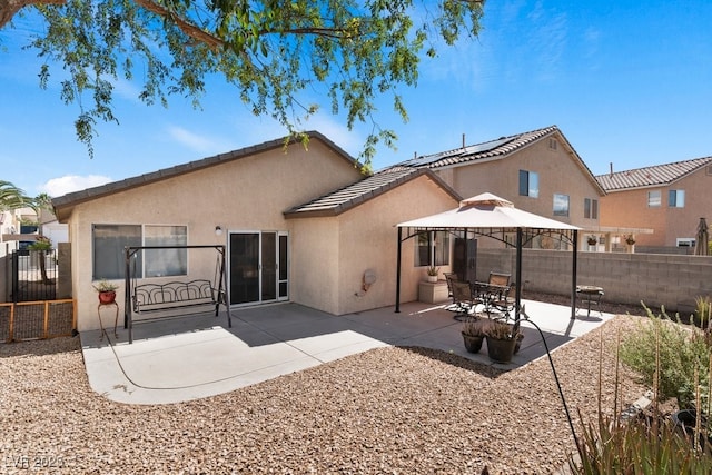 688 Castlebridge Ave, Las Vegas, NV 89123 - back of house with stucco siding, a gazebo, a fenced backyard, a patio area, and a tile roof