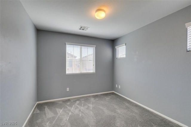 carpeted spare room with baseboards