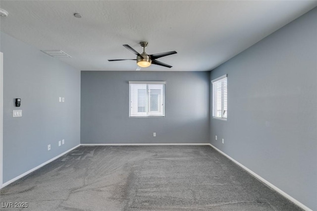 unfurnished room featuring carpet flooring, baseboards, and a ceiling fan