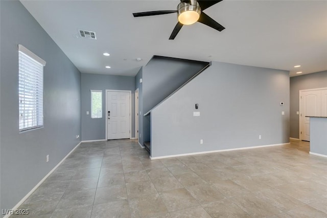 unfurnished living room with ceiling fan, recessed lighting, and baseboards