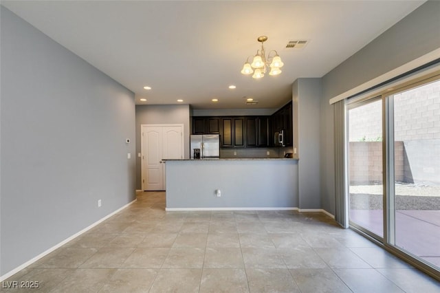 kitchen with appliances with stainless steel finishes, a chandelier, light tile patterned floors, recessed lighting, and baseboards