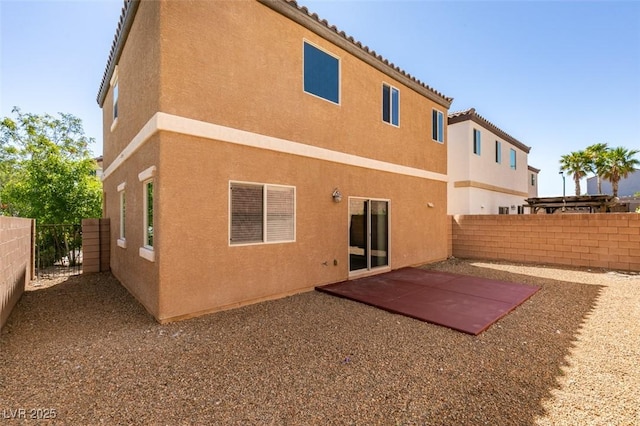 back of property featuring stucco siding, a fenced backyard, and a patio
