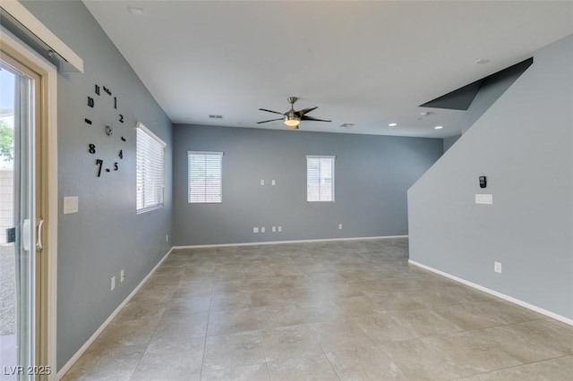 unfurnished room featuring healthy amount of natural light, ceiling fan, and baseboards