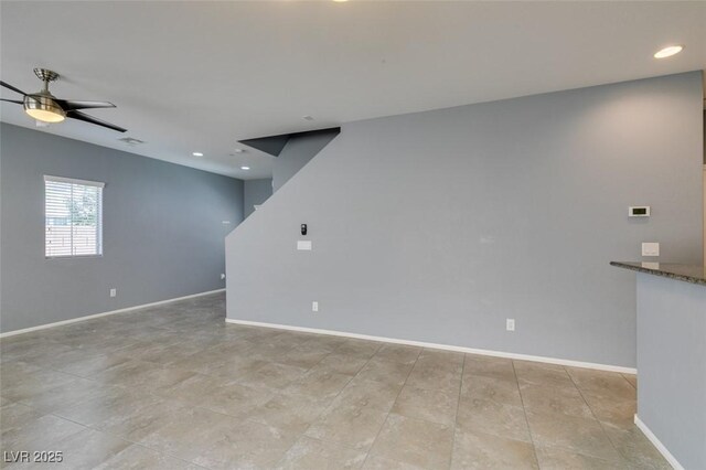spare room with a ceiling fan, baseboards, and recessed lighting