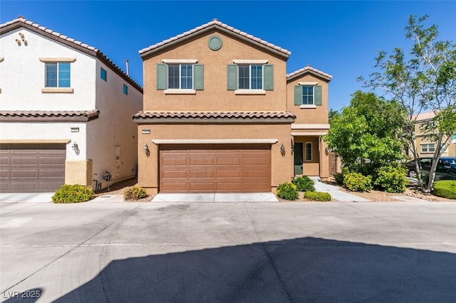view of front facade with an attached garage, driveway, stucco siding, and a tiled roof