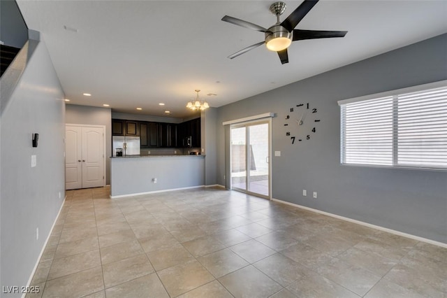 unfurnished living room with a chandelier, recessed lighting, a ceiling fan, baseboards, and light tile patterned floors