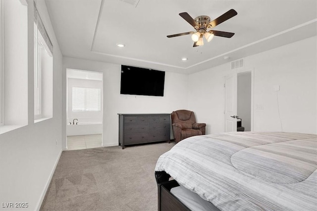 carpeted bedroom with a tray ceiling, recessed lighting, baseboards, and a ceiling fan