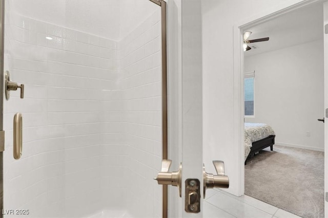 ensuite bathroom featuring a stall shower and baseboards