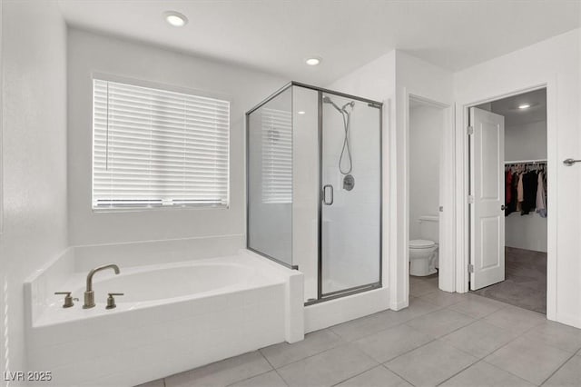 bathroom with a stall shower, a bath, tile patterned flooring, toilet, and recessed lighting