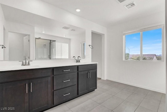 full bathroom with a shower stall, baseboards, tile patterned floors, double vanity, and recessed lighting