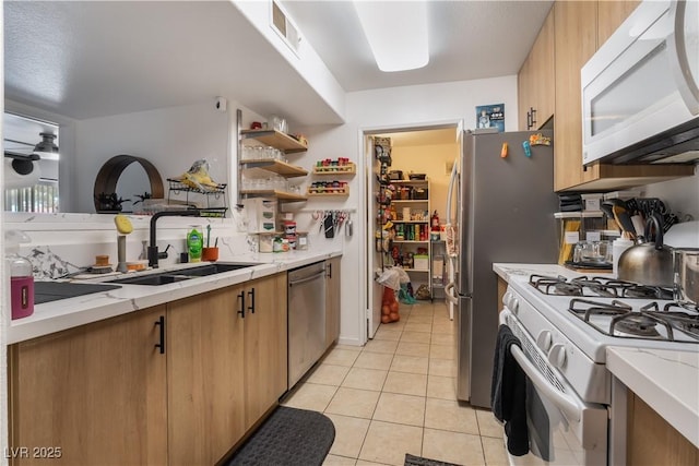 7885 W Flamingo Rd Unit 1161, Las Vegas, NV 89147 - kitchen with white appliances, a sink, light tile patterned floors, and light stone countertops