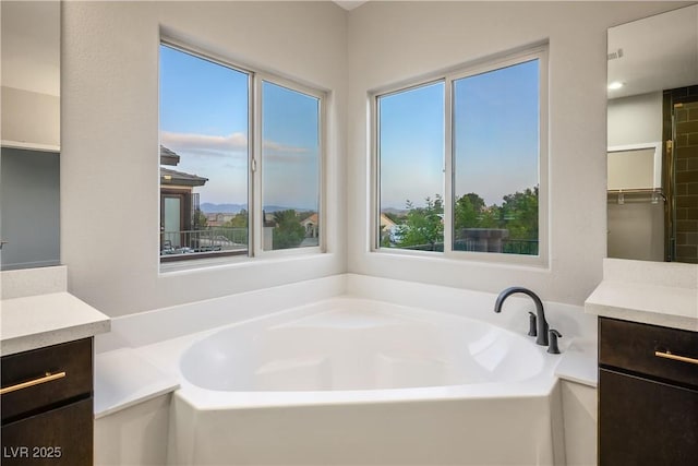 bathroom featuring vanity and a garden tub