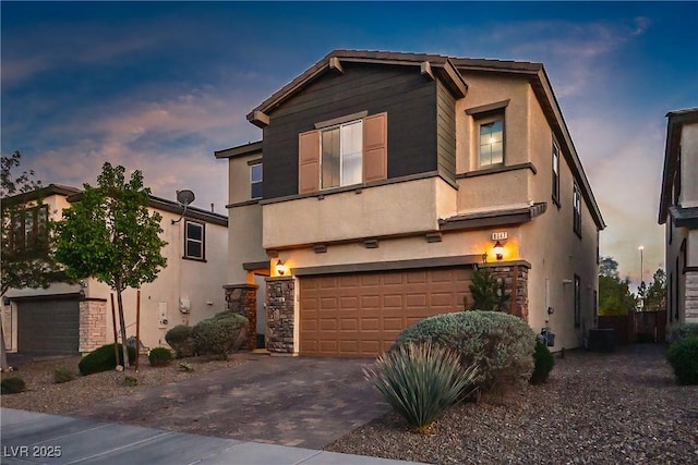 view of front of house featuring stucco siding, driveway, a garage, and central AC unit
