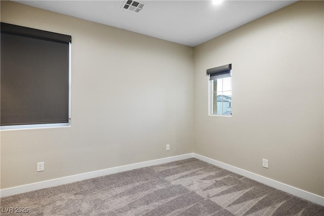 carpeted spare room with baseboards
