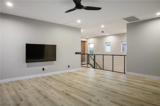 unfurnished living room with a ceiling fan, light wood finished floors, baseboards, and recessed lighting
