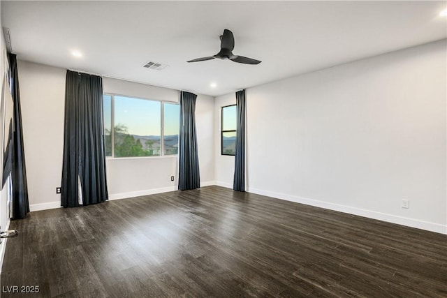 unfurnished room featuring dark wood finished floors, a ceiling fan, baseboards, and recessed lighting
