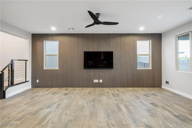unfurnished living room with wood finished floors, ceiling fan, recessed lighting, and baseboards