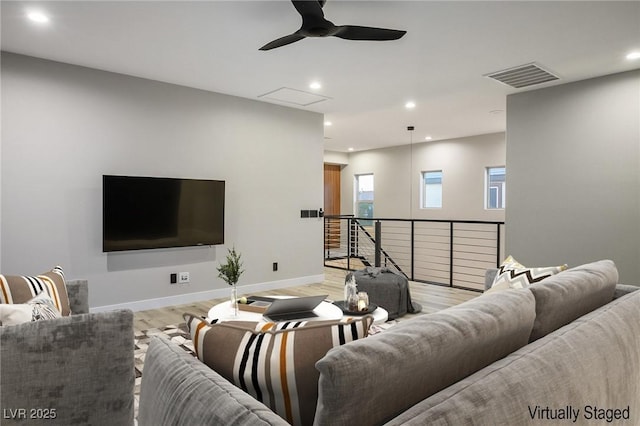 living room with light wood-style floors, ceiling fan, baseboards, and recessed lighting