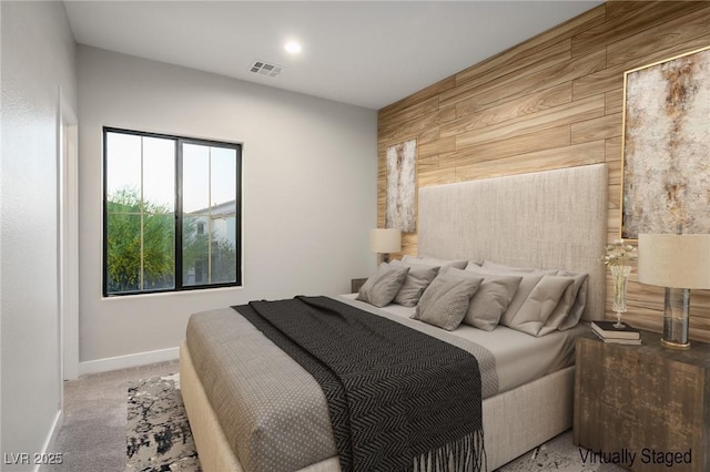 bedroom featuring wood walls and baseboards