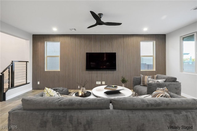 living area with baseboards, recessed lighting, wood finished floors, and a ceiling fan